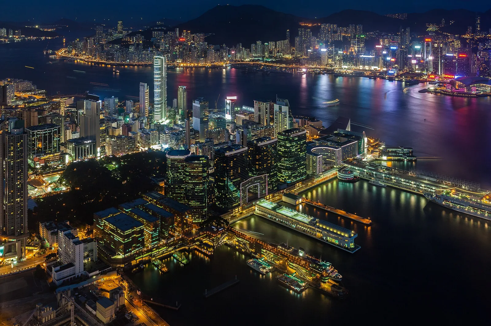 The Hong Kong Island skyline seen across Victoria Harbour from Kowloon, with ferries on the water