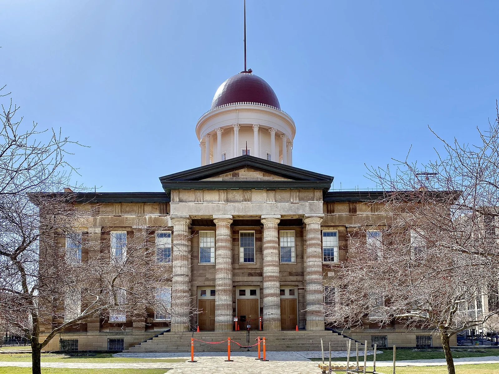 The domed Illinois State Capitol building in Springfield, seen across its lawn on a clear day