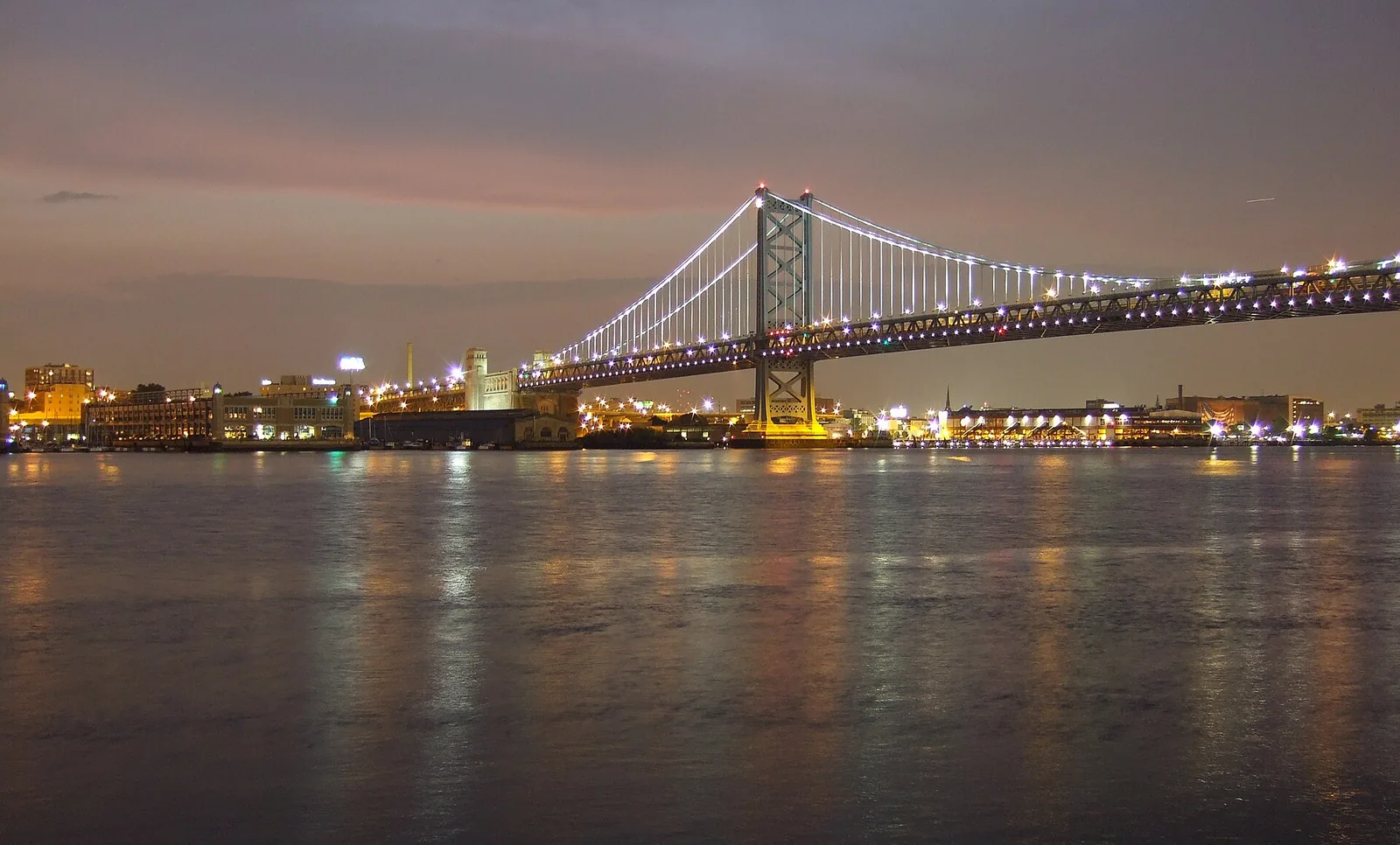 The Benjamin Franklin Bridge at dusk, carrying traffic across the Delaware River between Philadelphia and New Jersey