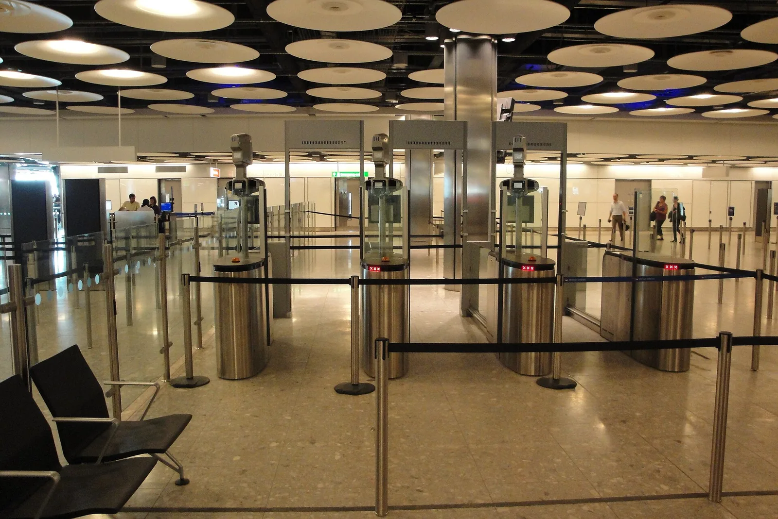 Rows of automated ePassport gates standing empty in an airport arrivals hall