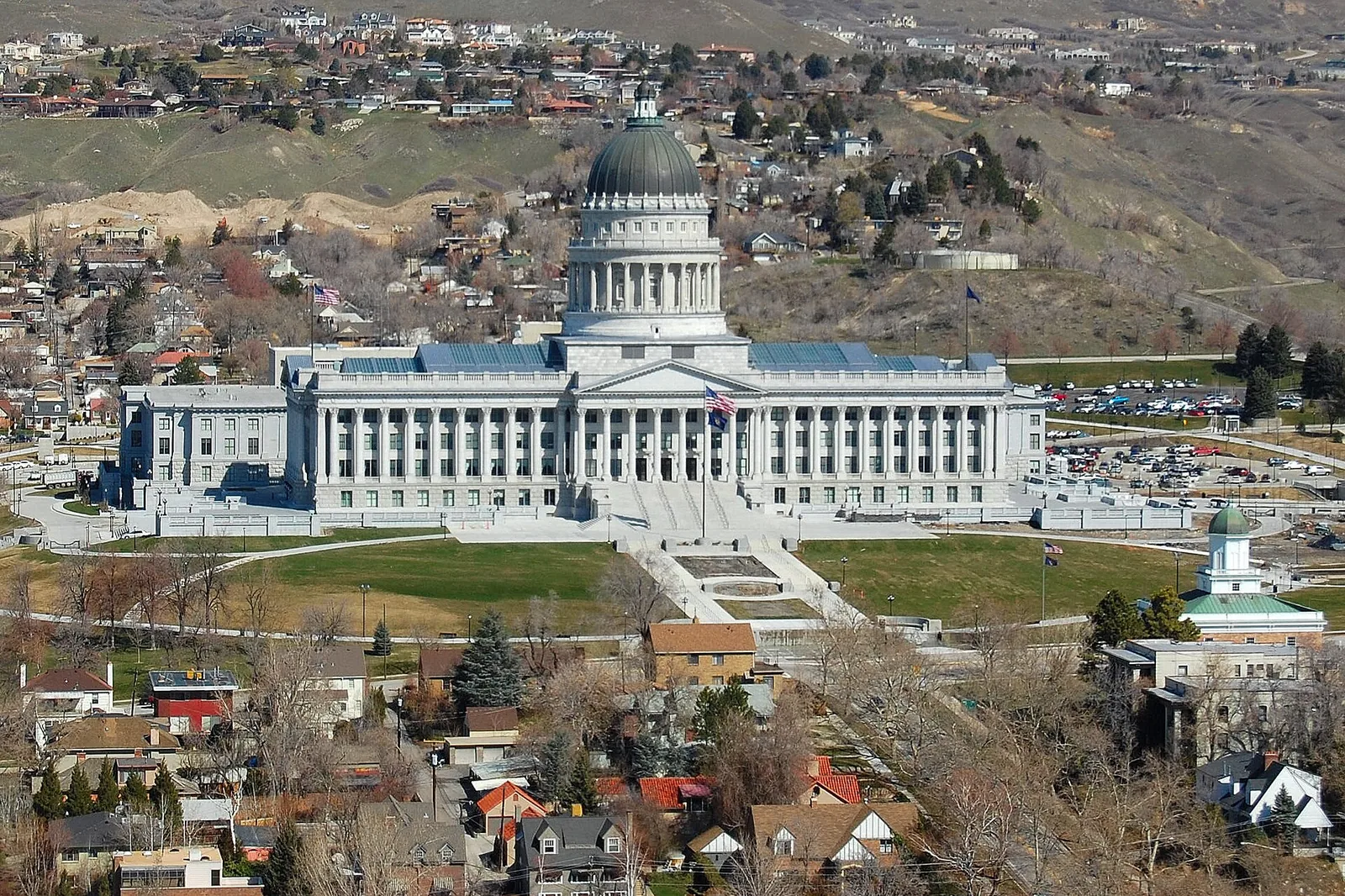 The domed Utah State Capitol building in Salt Lake City, with mountains rising behind it